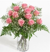 Bouquet of red or pink roses with babyes breath and greenery