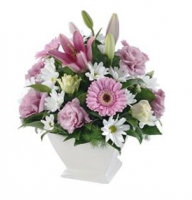 Arrangement in pink colours of gerberas, roses and lilies